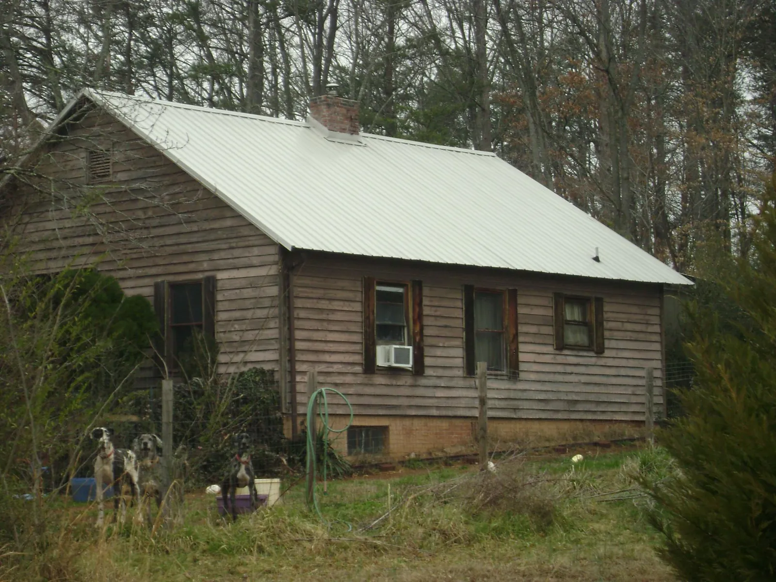 White metal roof on an old wood sided farmhouse, from a Metal Roof Installation job in Biscoe